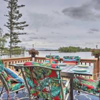 a table and chairs on a deck next to the water at Updated Lake House Dock, Boats, and Paddle Board!, Big Lake