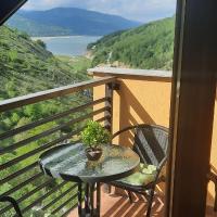 a table and chairs on a balcony with a view at Filip Apartment, Mavrovo