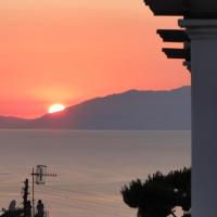 a sunset over a body of water with a mountain at Hotel Bussola, Anacapri