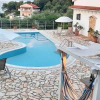 a swimming pool with white chairs and an umbrella at Villa Olive Grove and sea view, St. Spyridon Corfu