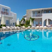 a swimming pool with chairs and a building at Katerina Hotel, Agios Prokopios
