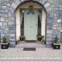 a door in a stone building with potted plants at Lír B&B, Multyfarnham