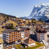 a city with a mountain in the background at Derby Swiss Quality Hotel, Grindelwald