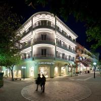 a building with people walking in front of it at night at Hotel Hermes, Rhodes Town