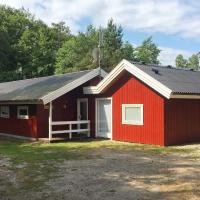 a red shed with a white door at Magnificent Holiday Home In Nex With Sauna, Vester Sømarken