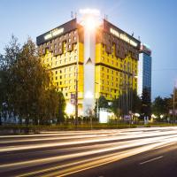 a yellow building with the light on top of it at Hotel Holiday, Sarajevo