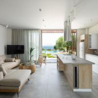a kitchen and living room with a couch and a table at Luria Homes, Lagomandra