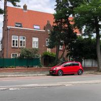 a red car parked on the side of a street at B&B Bommelsteijn, Dordrecht