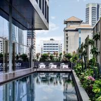 a swimming pool in a city with buildings at YOTEL Singapore Orchard Road