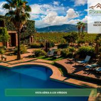 a magazine advertisement for a resort with a swimming pool and a vineyard at Hotel Boutique Valle de Guadalupe