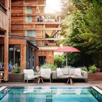 a patio with a pool in front of a building at Small Luxury Hotel of the World - DasPosthotel, Zell am Ziller
