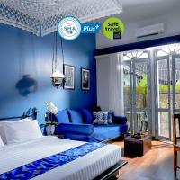 a blue bedroom with a bed and a couch at The Memory at On On Hotel - SHA Extra Plus, Phuket Town