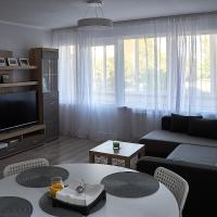 a living room with a couch and a table at Rundale Solstice Apartment, Pilsrundāle