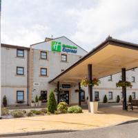 an image of a hotel with a gas station at Holiday Inn Express Perth, an IHG Hotel