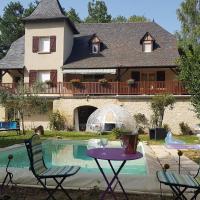 a house with a table and chairs next to a pool at Fred et Jules, Beaulieu-sur-Dordogne