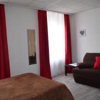 a bedroom with a bed and a couch and red curtains at Hôtel de La Croix de Malte, Cherbourg en Cotentin