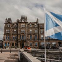 a large building with a flag in front of it at The Kirkwall Hotel