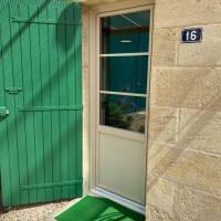 a green door on a building with a green floor at 16 CHEMIN DE BOISBELET, Coutras