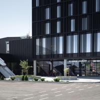 a large black building with a lot of windows at Scandic Hamar
