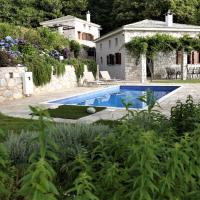 a swimming pool in a yard next to a house at Kastania Villas- Villa K3, Pouríon
