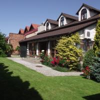 a large house with a lawn in front of it at Villa Del Arte Bed & Breakfast, Wadowice