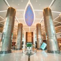 a lobby of a hotel with columns and a large blue drop at FLY INN BAKU, Baku