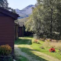 a yard with a building and a house at Kinlochewe Mountain Chalets - Chalet 3, Birch