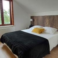 a bedroom with a large bed with a wooden headboard at Hotel La Cascada, Bredene