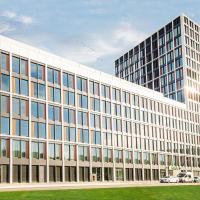 a large white office building with a lot of windows at Holiday Inn - Mannheim City - Hauptbahnhof, an IHG Hotel