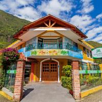 a building with a sign in front of it at La Floresta Hotel, Baños
