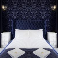 a bedroom with a large bed with a blue headboard at The Pier Hotel, Eastbourne