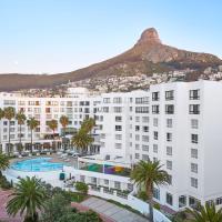 a large white building with a mountain in the background at President Hotel, Cape Town