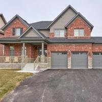 a brick house with two garage doors in a driveway at Entire house for your getaway!, Carrying Place