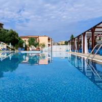 a swimming pool with blue water in a resort at Marina Apartments, Agios Gordios