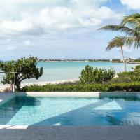 a swimming pool with a view of the beach at SulMare at Sapodilla Bay Luxury villas, Providenciales