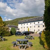 a group of picnic tables in front of a building at The Caledonian Hotel, Fort William