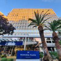a building with two palm trees in front of it at Hotel Princesa Plaza Madrid
