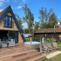 Widgeon Bespoke Cabin is lakeside with Private fishing peg, hot tub situated at Tattershall Lakes Country Park