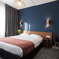 a hotel room with a large bed and a desk at le paris brest hotel, Rennes