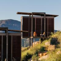 a house on the side of a hill with chairs at Encuentro Guadalupe, Valle de Guadalupe