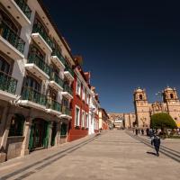 a street in a city with two towers at Hotel Hacienda Plaza de Armas, Puno