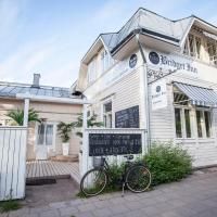 a bike parked in front of a white building at Bridget Inn, Naantali