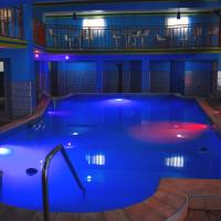 a large swimming pool with blue lighting in a building at La Pepiniere Hotel, Petionville