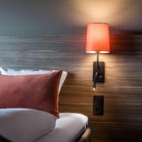 a bedroom with a bed with a lamp and a pillow at Scandic Glostrup