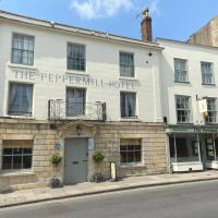 a large white building on the corner of a street at The Peppermill Town house Hotel & Restaurant, Devizes