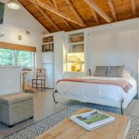 a bedroom with a bed and a table in a room at Sprucewold Beach House, Boothbay Harbor