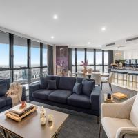 a living room with couches and a table at Meriton Suites Herschel Street, Brisbane