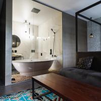 a bathroom with a bath tub and a couch and a bath tub at Sofa Boutique Hotel & SPA, Sumy