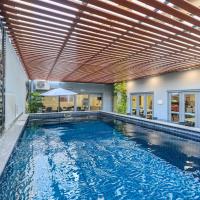 an indoor swimming pool with a wooden ceiling at Argus Hotel Darwin