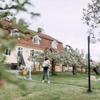 two girls are standing in front of a house at Tammiston Bed&Breakfast, Naantali